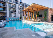 Thumbnail 14 of 21 - a swimming pool in front of an apartment building with a poolat Sterling Nashville West Apartments, Nashville, 37209