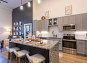 Thumbnail 4 of 21 - an open kitchen and dining room with stainless steel appliancesat Sterling Nashville West Apartments, Nashville