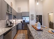 Thumbnail 5 of 21 - a kitchen with granite counter tops and stainless steel appliancesat Sterling Nashville West Apartments, Nashville, Tennessee
