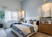 Thumbnail 8 of 21 - a bedroom with a bed and a dresserat Sterling Nashville West Apartments, Nashville, 37209