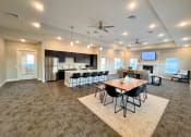 Thumbnail 4 of 16 - a large living room with a dining room table and a kitchen