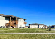 Thumbnail 12 of 16 - a group of houses on the side of a field