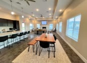 Thumbnail 5 of 16 - a conference room with a wooden table and chairs and a kitchen with a large window