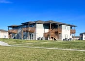 Thumbnail 13 of 16 - a house with wooden balconies on the side of a field