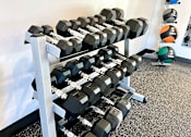 Thumbnail 27 of 35 - a row of weights on a rack in a gym