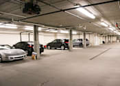 Thumbnail 16 of 18 - A parking garage with several cars parked.
