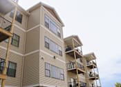 Thumbnail 13 of 18 - Apartment building with balconies and windows.