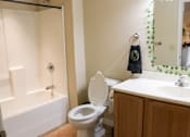 Thumbnail 2 of 18 - A bathroom with a toilet, sink, and bathtub.
