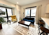 Thumbnail 6 of 35 - a living room with a couch and a coffee table