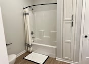 Thumbnail 23 of 35 - a small bathroom with a shower and a door