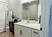 Thumbnail 22 of 35 - a bathroom with a sink and a mirror