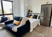 Thumbnail 19 of 35 - a living room with a couch and a bed