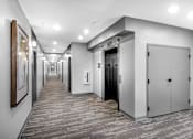 Thumbnail 30 of 35 - a corridor of elevators and doors in a building