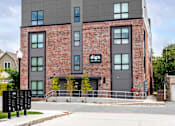 Thumbnail 34 of 35 - a brick building with a sign on the side of it