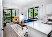 Thumbnail 5 of 35 - a living room with a kitchen and a large window