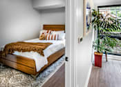 Thumbnail 8 of 35 - a bedroom with a bed and a large window