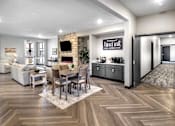 Thumbnail 18 of 35 - A modern living room with a coffee bar and a fireplace.