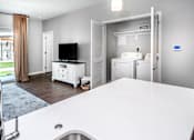 Thumbnail 4 of 35 - A modern kitchen with a white countertop and a stainless steel sink.