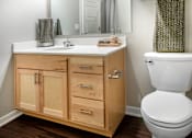 Thumbnail 9 of 35 - A white toilet sits next to a sink in a bathroom.