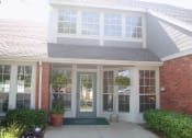 Thumbnail 3 of 3 - The Northpark Apartments clubhouse exterior with a pathway leading to the entrance.