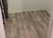 Thumbnail 15 of 15 - Utility/furnace closet in the Yeakel Townhome, featuring a wooden floor and white walls.