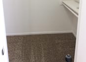 Thumbnail 9 of 15 - Master bedroom closet in the Yeakel Townhome, featuring a carpeted floor and a shelf for storage.