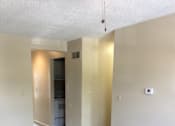 Thumbnail 3 of 15 - Living room in the Yeakel Townhome, featuring a carpeted floor and a wall.