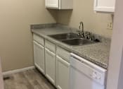 Thumbnail 6 of 15 - Kitchen in the Yeakel Townhome, featuring white cabinets and a countertop.