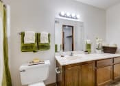 Thumbnail 34 of 35 - Bathroom in the one-bedroom model unit at Olde English Village, featuring a bathroom sink and water closet.