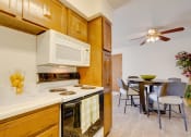 Thumbnail 24 of 35 - Well-equipped kitchen in the two-bedroom model unit at Olde English Village, offering plenty of storage and countertop space.