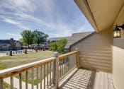 Thumbnail 18 of 35 - Balcony of a two-bedroom model unit at Olde English Village, offering outdoor space with views of the surrounding community.