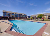 Thumbnail 9 of 35 - Surrounded by the beauty of the clubhouse grounds, the sparkling pool invites residents to relax and enjoy leisurely moments.