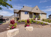 Thumbnail 2 of 35 - Exterior view of the clubhouse building at Olde English Village, surrounded by well-maintained landscaping and a welcoming atmosphere.
