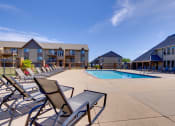 Thumbnail 8 of 35 - A sparkling outdoor pool at the clubhouse, with clear blue water and sun loungers, invites residents to relax, swim, and enjoy leisurely moments in a beautiful, serene setting.