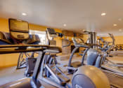 Thumbnail 13 of 35 - Olde English Village fitness center with treadmills, weights, and other exercise equipment.