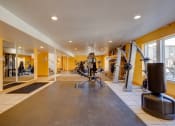Thumbnail 12 of 35 - The fitness center at Olde English Village, featuring a variety of exercise equipment in a well-lit space.