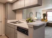 Thumbnail 9 of 16 - Cozy kitchen featuring wooden cabinetry, a sink, and ample counter space, perfect for home cooking.