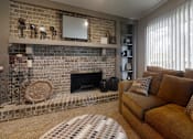 Thumbnail 14 of 17 - A cozy living room with a love seat, a fireplace, a floor clock, and a round coffee table, softly lit with warm lighting for a relaxing atmosphere.