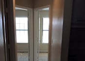 Thumbnail 7 of 15 - Upper hallway in the Yeakel Townhome, with a door on the left and a window on the right.