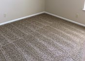 Thumbnail 8 of 15 - Upper bedroom in the Yeakel Townhome, featuring a carpeted floor and white baseboards.