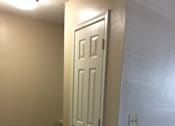 Thumbnail 5 of 15 - A white door leading to a coat closet in a room with carpeted flooring in the Yeakel Townhome.