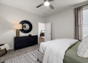 Thumbnail 16 of 43 - a bedroom with a bed and a ceiling fan