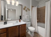 Thumbnail 14 of 43 - a bathroom with a toilet sink and shower and a mirror