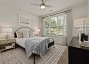 Thumbnail 21 of 43 - a bedroom with a bed and a ceiling fan