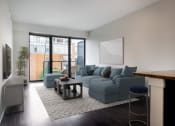 Thumbnail 28 of 28 - a living room with a blue couch and a coffee table