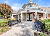 Thumbnail 34 of 43 - the front porch of a house with two benches and a walkway