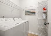 Thumbnail 15 of 43 - a white washer and dryer in a laundry room with a white closet