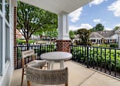 Thumbnail 24 of 43 - a patio with two chairs and a table on a balcony