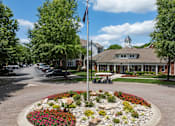 Thumbnail 33 of 43 - a flag pole in the middle of a flower garden in front of a house