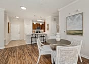 Thumbnail 8 of 32 - A dining room with a table and chairs.